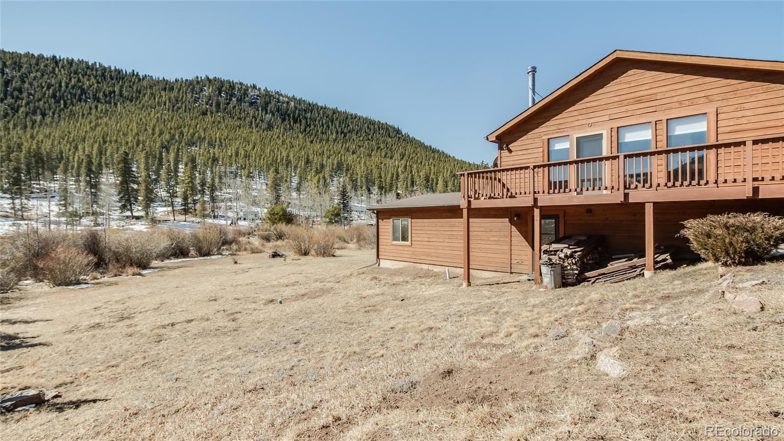 302 Bishop Road Bailey, CO 80421 - Photo 17 of 19 a view of a house with a yard