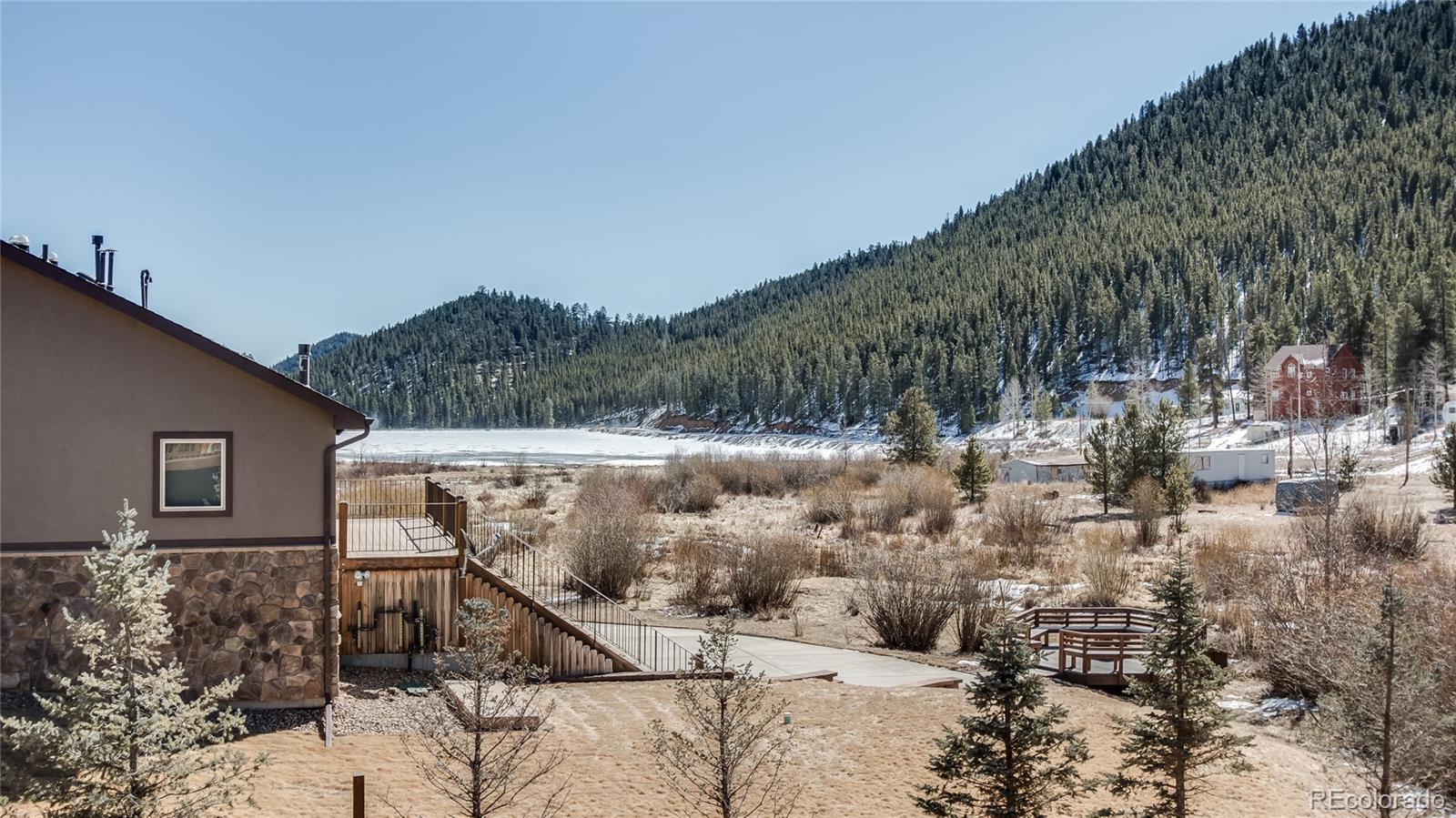 302 Bishop Road Bailey, CO 80421 - Photo 4 of 19 a view of a house with a yard
