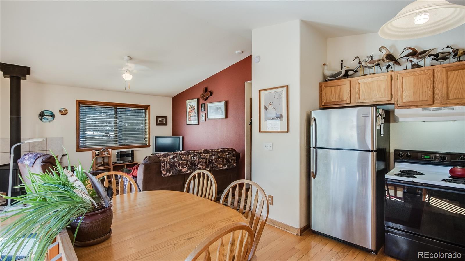302 Bishop Road Bailey, CO 80421 - Photo 10 of 19 a kitchen with stainless steel appliances granite countertop a refrigerator a stove a sink a dining table and chairs