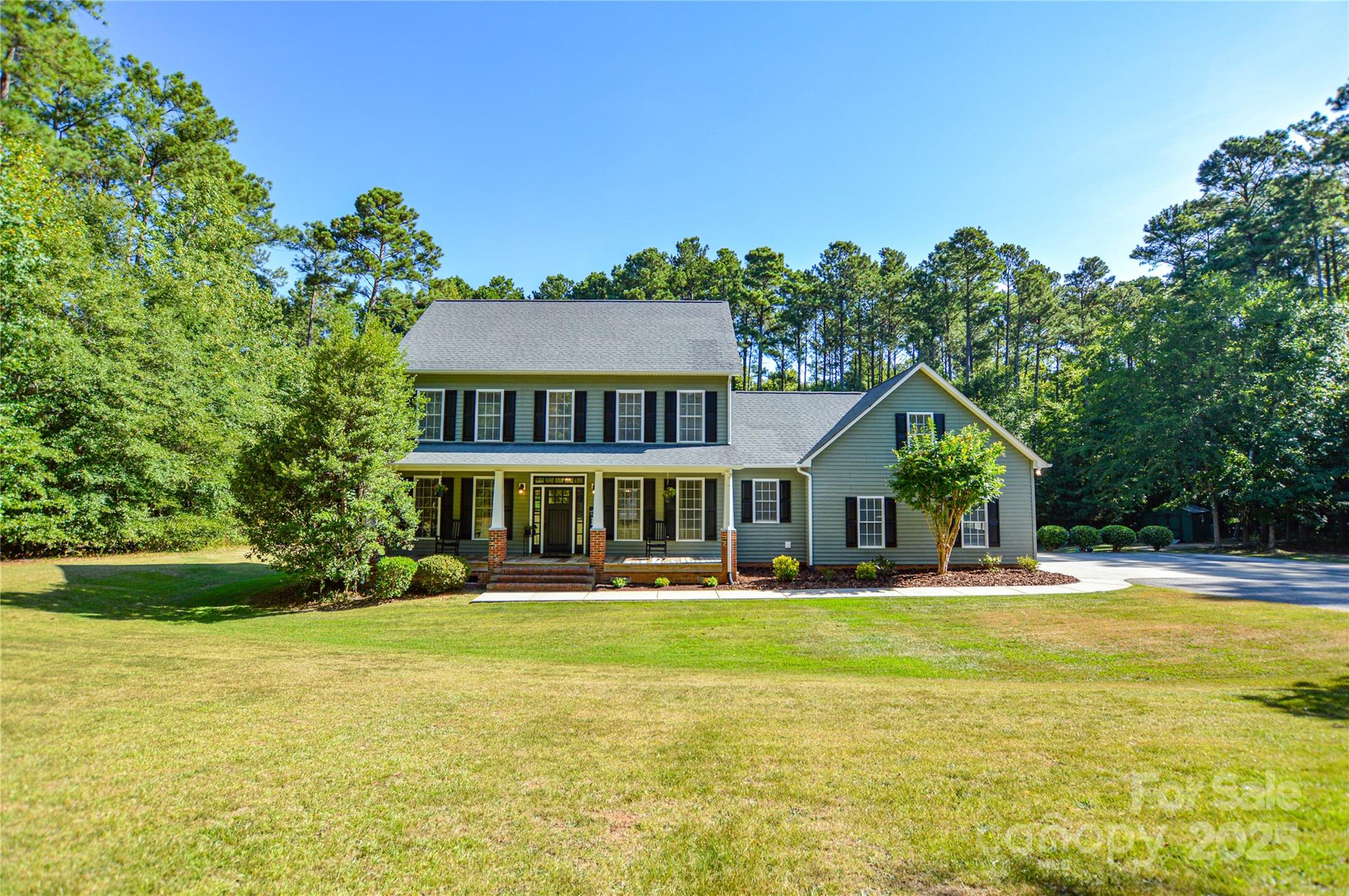 a front view of a house with a yard table and chairs