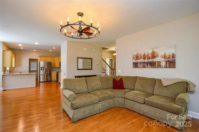 a living room with furniture and kitchen view