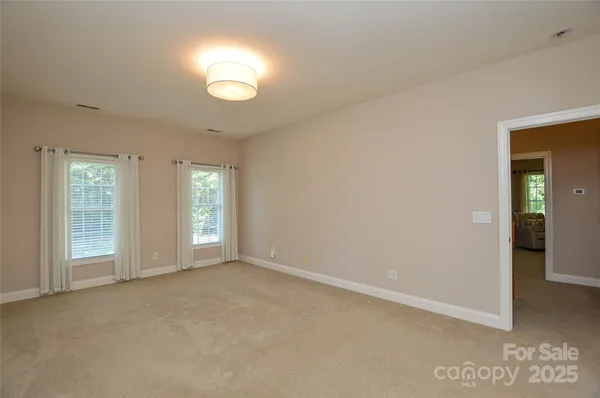 an empty room with windows and entrance