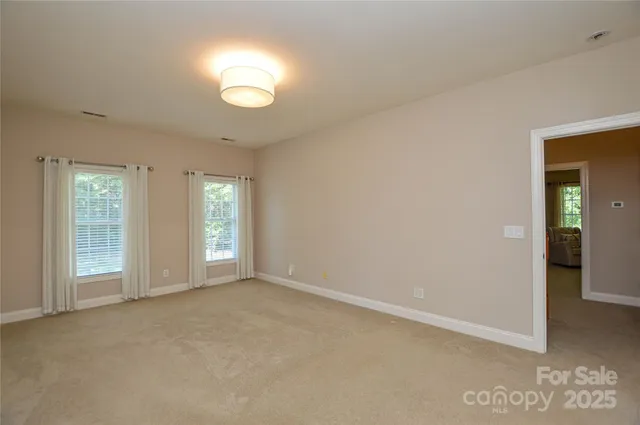 an empty room with windows and entrance