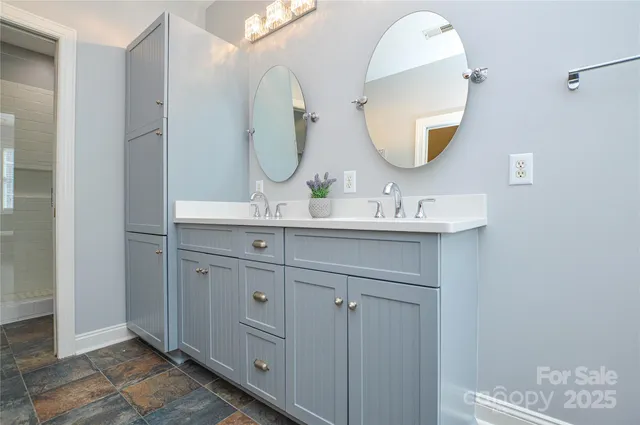 a bathroom with a double vanity sink and a mirror