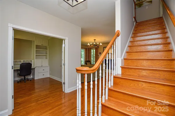 a view of entryway and hall with wooden floor