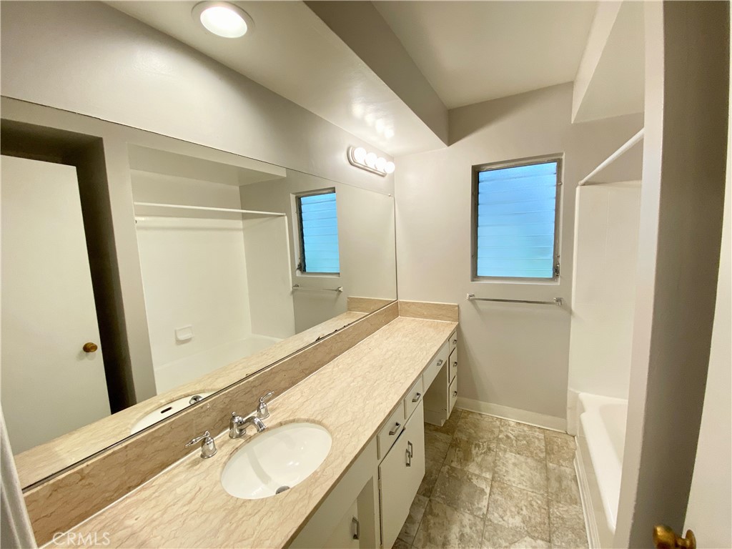 3335 Triangle Place, Unit 5 Glendale, CA 91208 - Photo 8 of 9 a bathroom with a granite countertop sink and a mirror