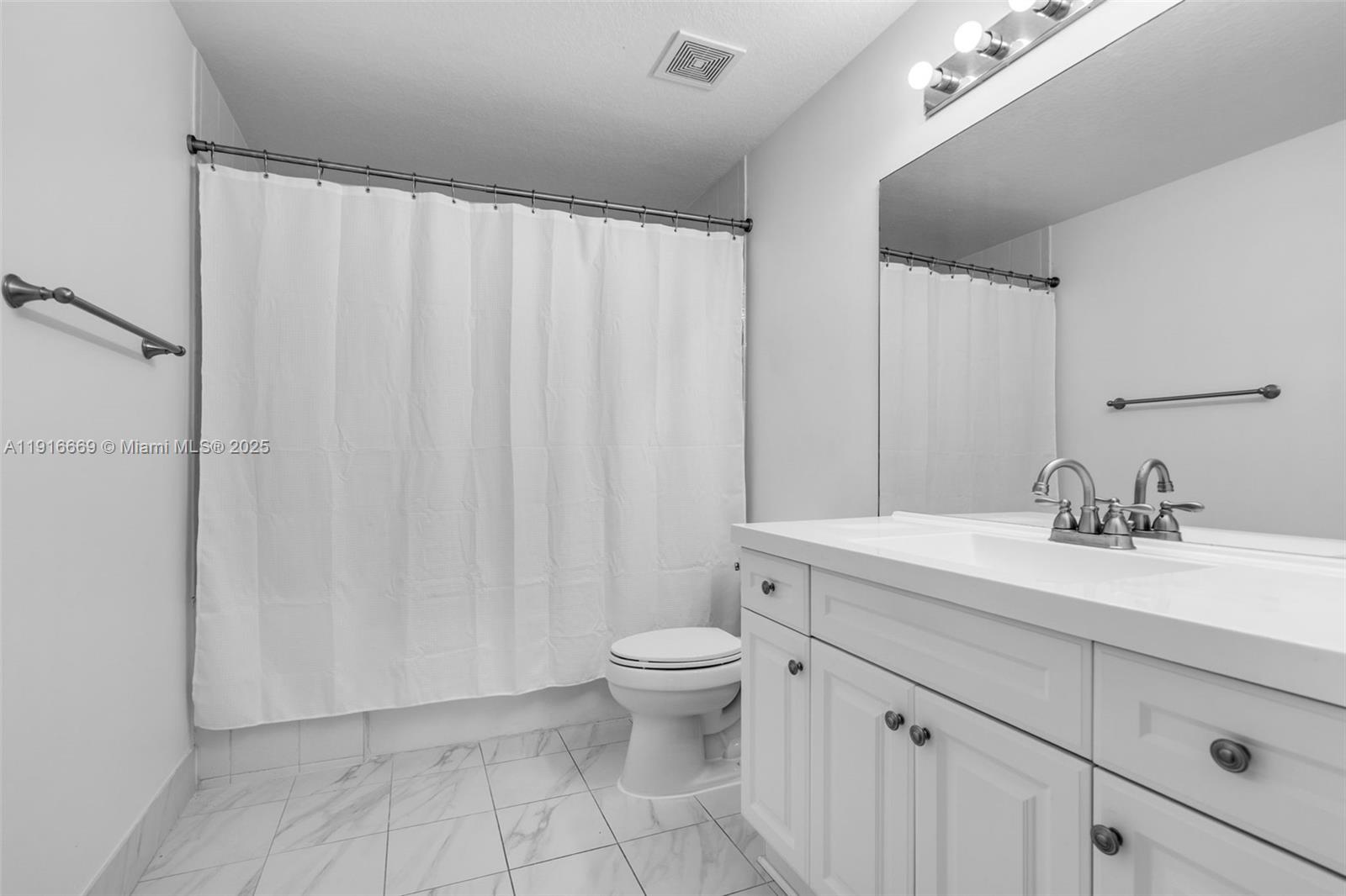 15057 Southwest 32nd Street Miami, FL 33165 - Photo 17 of 31 a bathroom with a granite countertop sink a toilet and a mirror