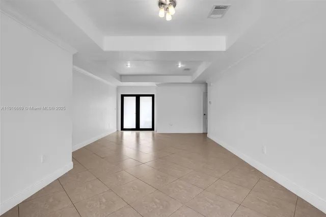 an empty room with windows and entrance