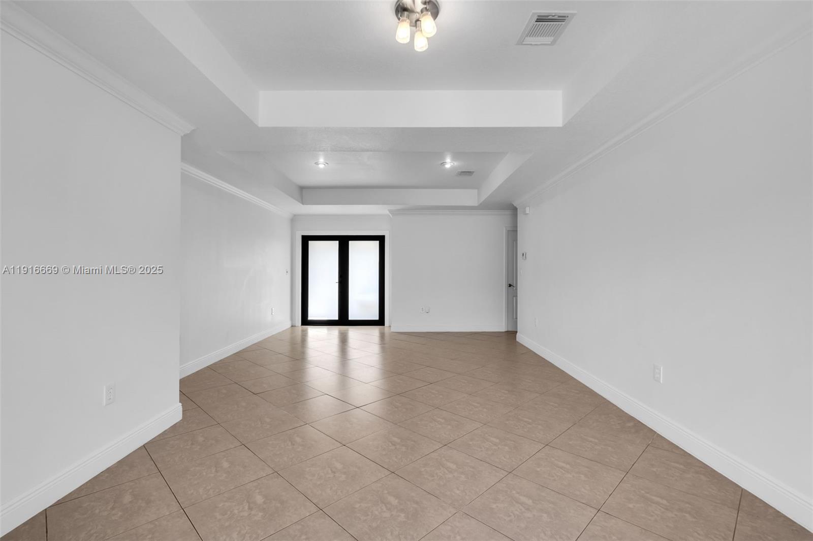 15057 Southwest 32nd Street Miami, FL 33165 - Photo 6 of 31 an empty room with windows and entrance
