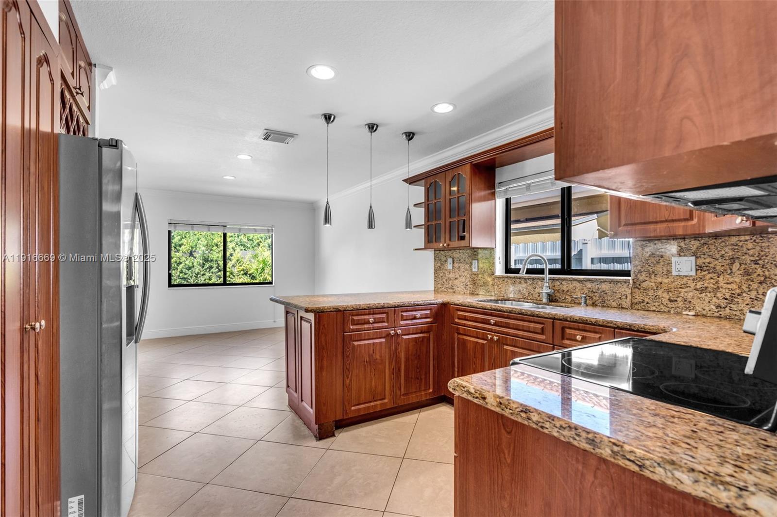 15057 Southwest 32nd Street Miami, FL 33165 - Photo 10 of 31 a kitchen with stainless steel appliances granite countertop a sink stove and refrigerator