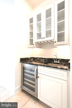 a kitchen with a stove a sink and cabinets