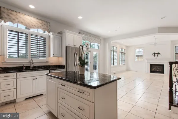 a view of a kitchen with a sink and a fireplace