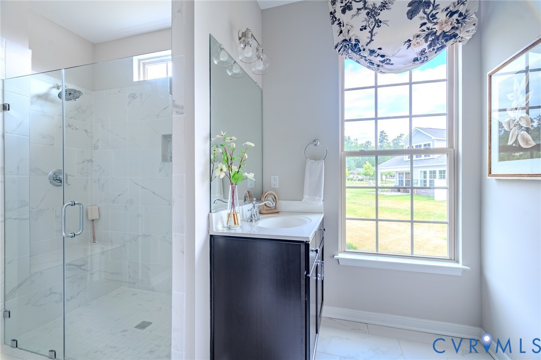 16025 Canoe Pointe Loop Moseley, VA 23120 - Photo 5 of 6 a bathroom with a shower sink and mirror