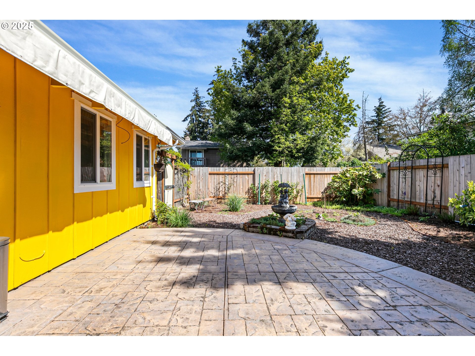 1170 Cal Young Road Eugene, OR 97401 - Photo 11 of 40 a view of a patio with table and chairs with wooden fence and plants