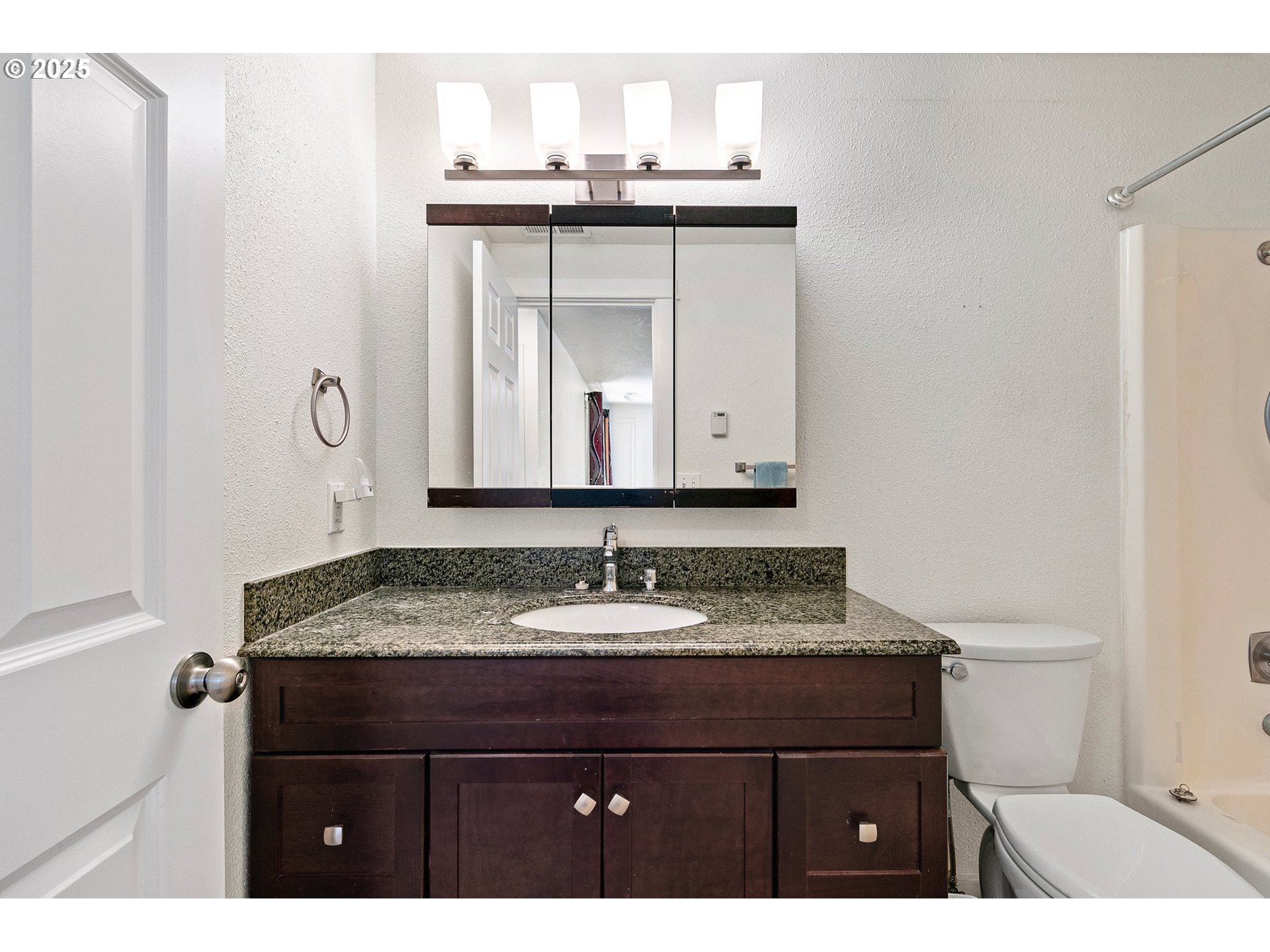 1170 Cal Young Road Eugene, OR 97401 - Photo 16 of 40 a bathroom with a granite countertop sink a toilet and a mirror