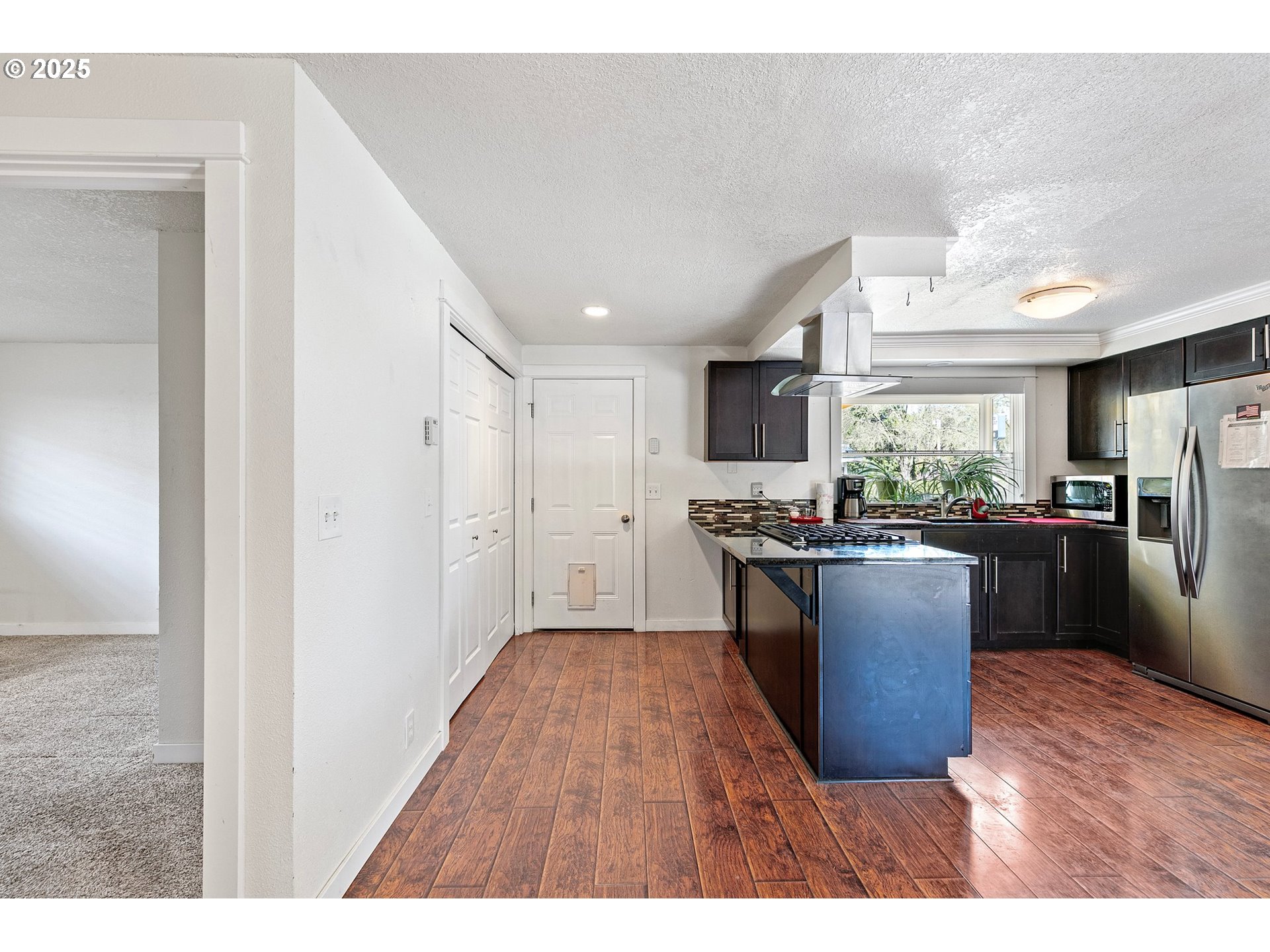 1170 Cal Young Road Eugene, OR 97401 - Photo 19 of 40 a kitchen with stainless steel appliances granite countertop a refrigerator a sink dishwasher a stove with wooden floor