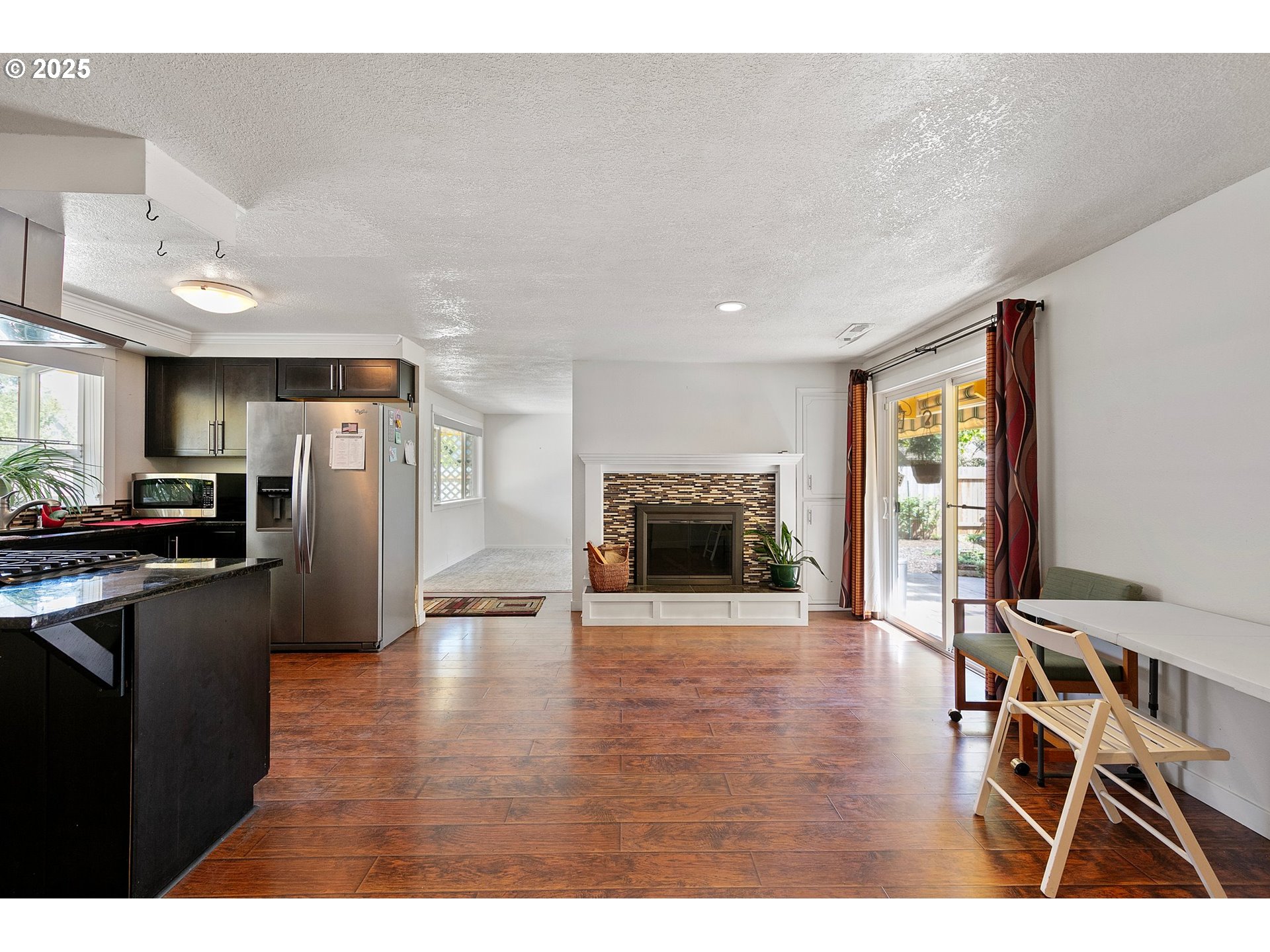 1170 Cal Young Road Eugene, OR 97401 - Photo 20 of 40 a view of a kitchen with a sink a refrigerator and wooden floor