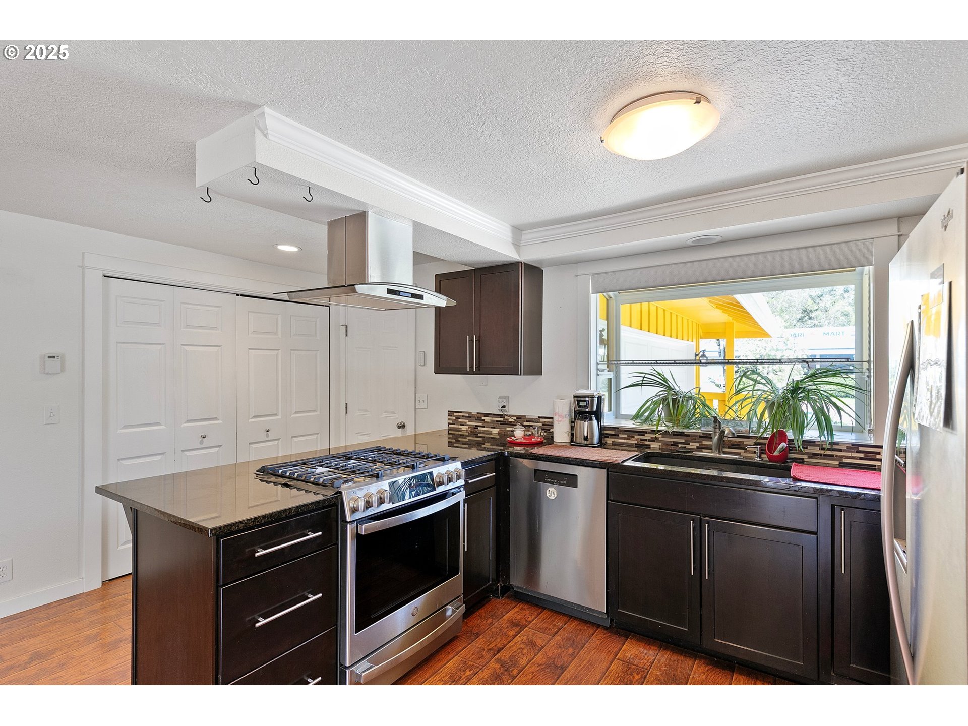 1170 Cal Young Road Eugene, OR 97401 - Photo 23 of 40 a kitchen with a sink stove and cabinets