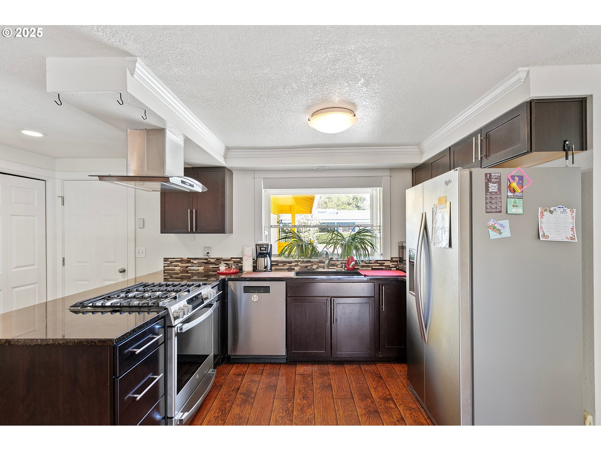 1170 Cal Young Road Eugene, OR 97401 - Photo 24 of 40 a kitchen with stainless steel appliances a stove a refrigerator and a sink