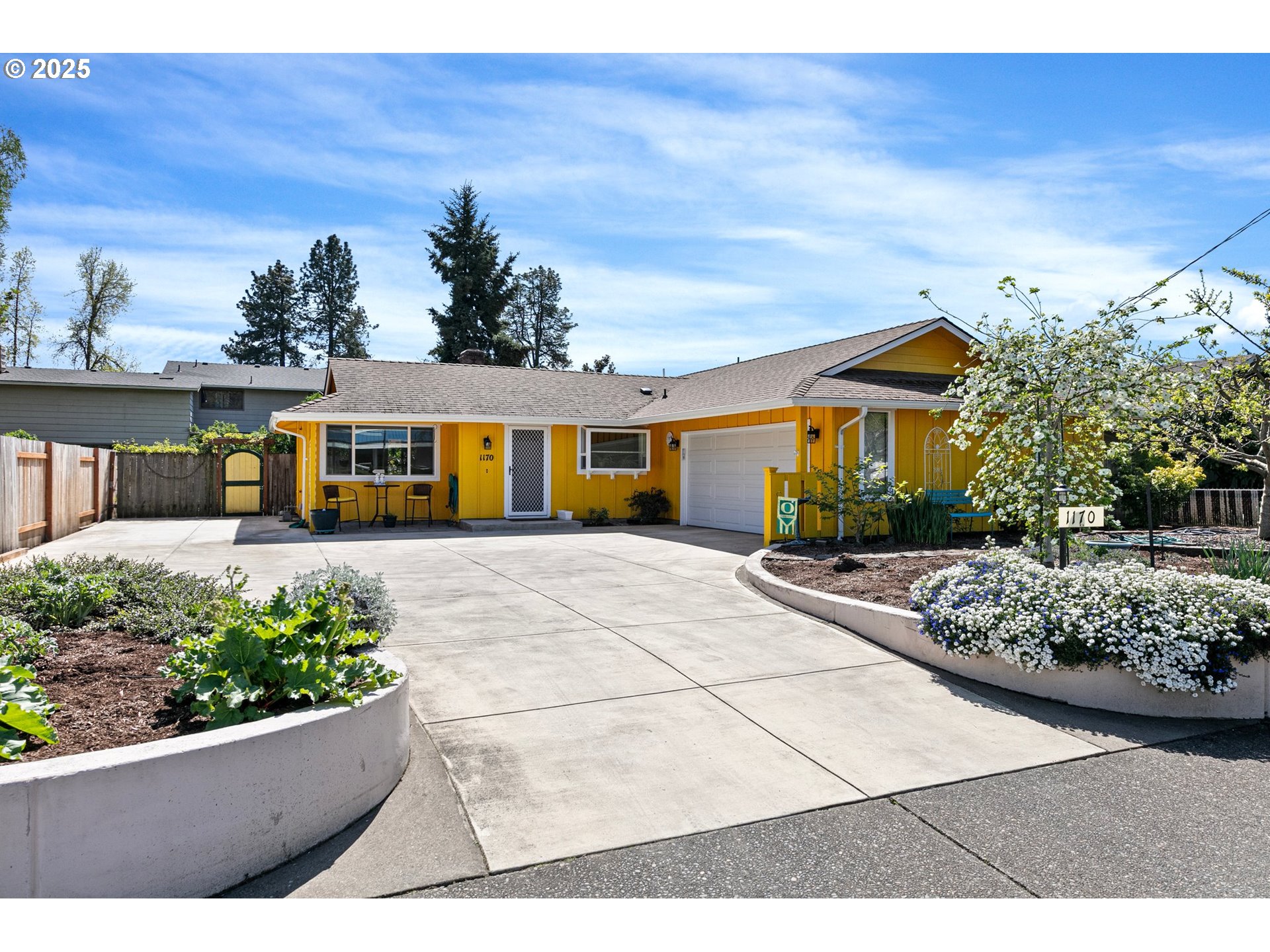 1170 Cal Young Road Eugene, OR 97401 - Photo 6 of 40 a view of a white house with a small yard and potted plants