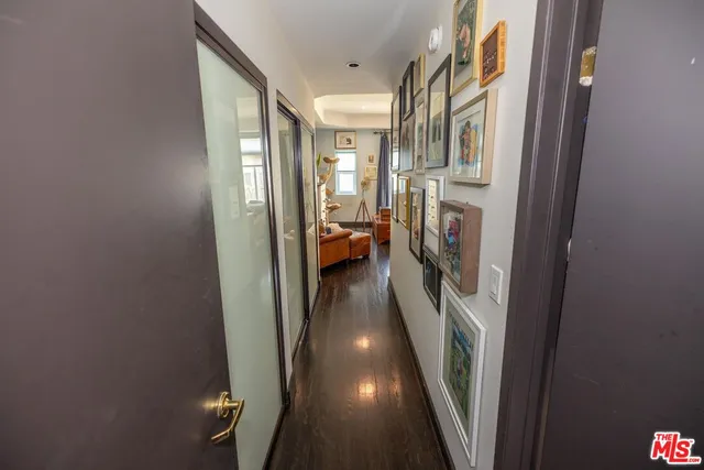 a view of a hallway with wooden floor and staircase