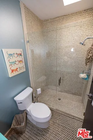a bathroom with a toilet and a shower