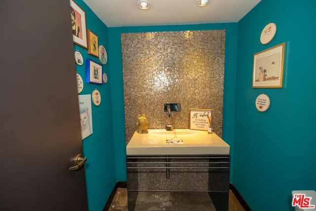 a large white kitchen with stainless steel appliances a stove a sink and a microwave