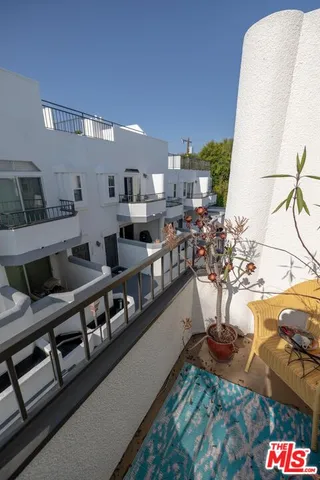 a living room with furniture fireplace and a large window
