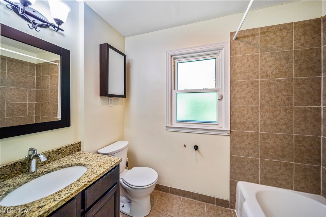 1796 Lander Road Mayfield Heights, OH 44124 - Photo 22 of 39 Full bathroom featuring tile patterned floors, tiled shower / bath combo, vanity, and toilet