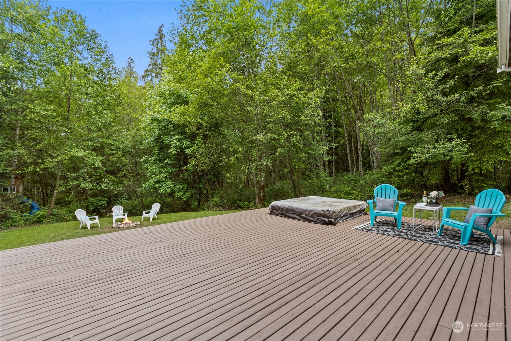 306 South Lake Roesiger Road Snohomish, WA 98290 - Photo 32 of 40 a view of a wooden deck with chairs and large trees