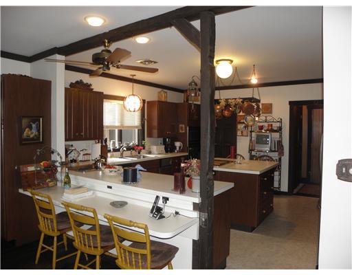 1255 Country Club Road Monongahela, PA 15063 - Photo 8 of 18 Kitchen. Great Breakfast Bar from Dining Room to Kitchen w/ Attractive Barn Wood Beams & Cedar Woodwork plus seats at Kitchen Island