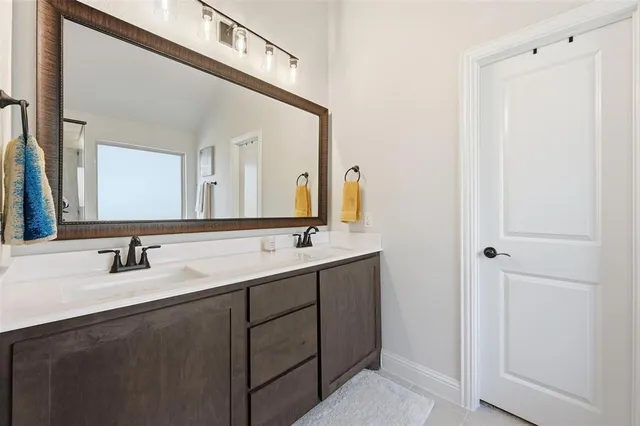 a bathroom with a double vanity sink and a mirror