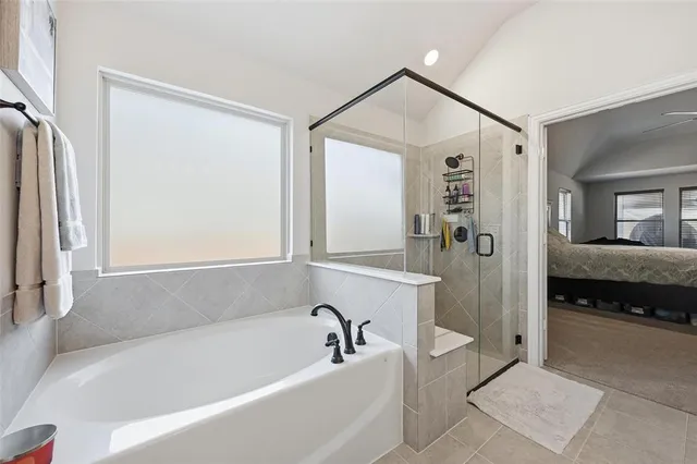 a bathroom with a bathtub and a shower