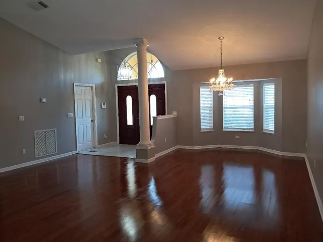 a front view of a house with a yard and a garden