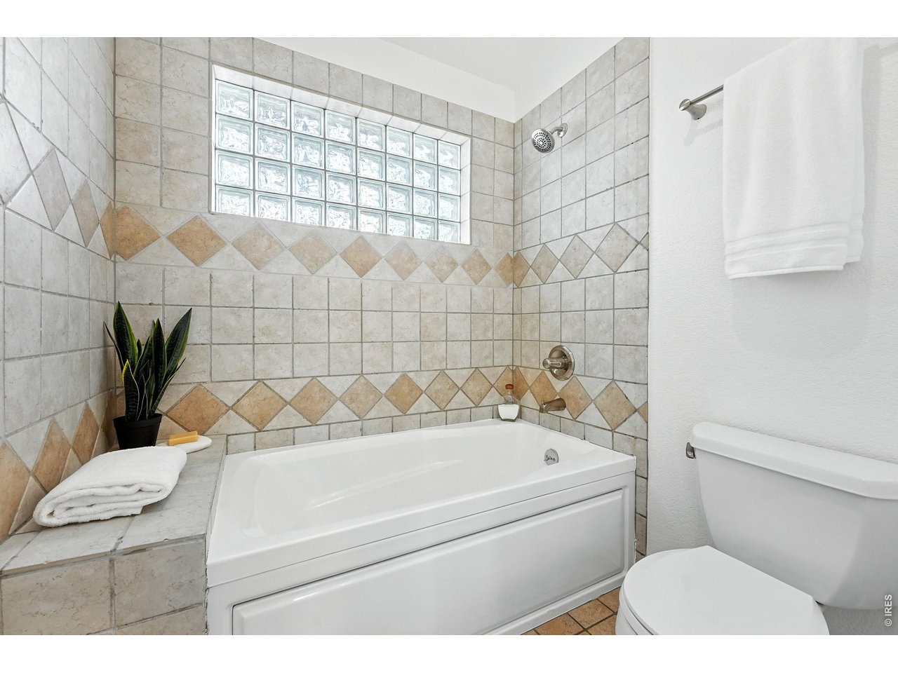 4557 Apple Way Boulder, CO 80301 - Photo 35 of 42 Bright and efficient, the bathroom connecting the two bedrooms includes a tub-shower combination and single sink, balancing practicality with ease of living.