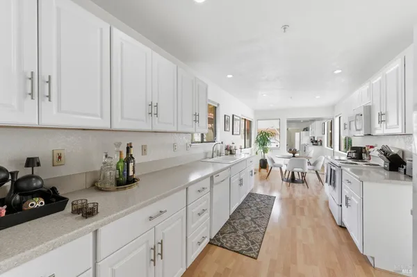 a kitchen with lots of counter top space and wooden floor