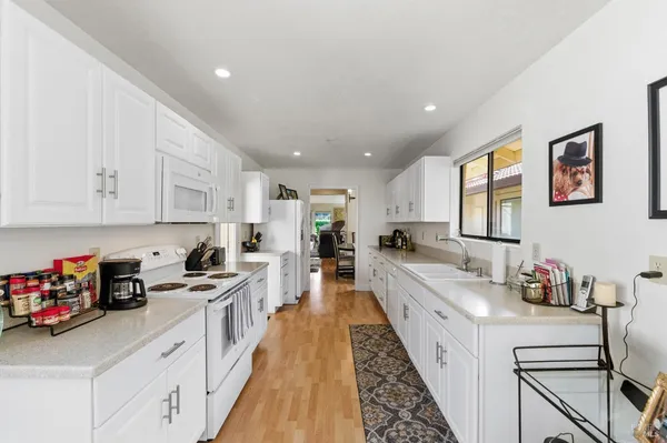a kitchen with cabinets a sink and appliances