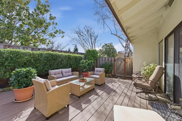 a view of a patio with couches and potted plants