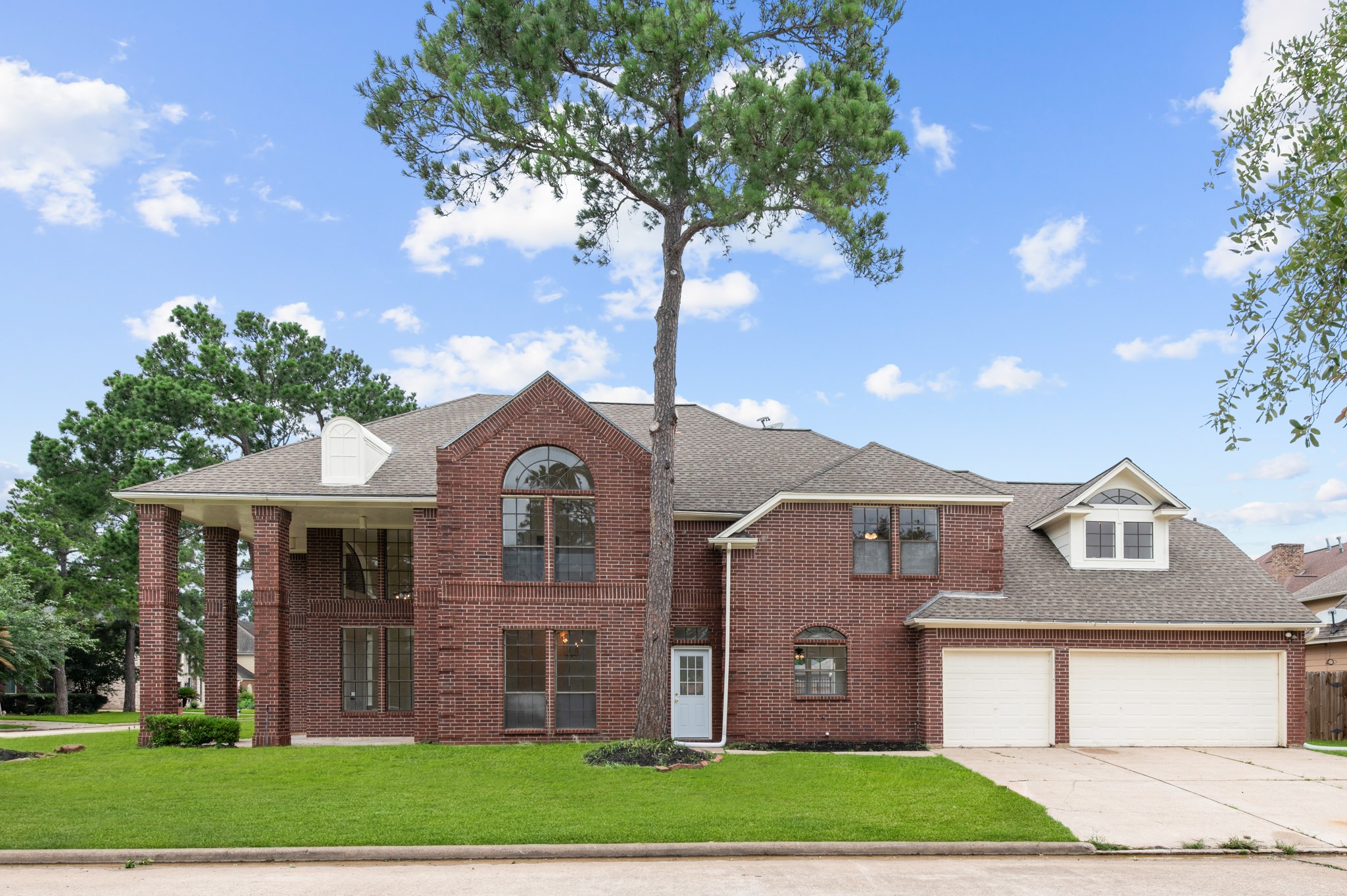 17402 Wilton Park Court Spring, TX 77379 - Photo 1 of 50 a front view of a house with a garden and trees