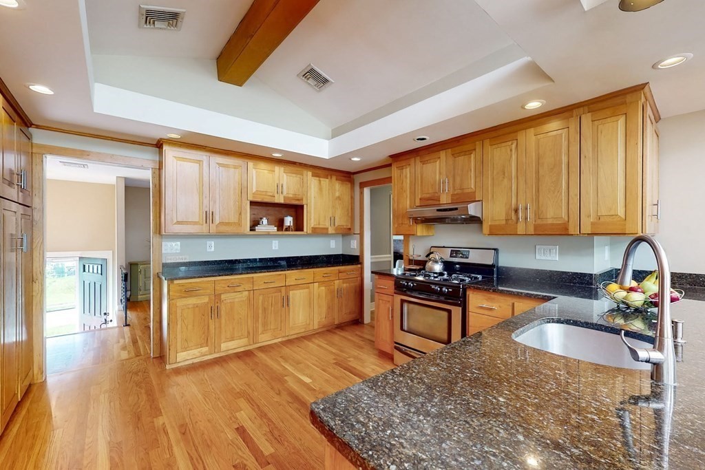 11 Stagecoach Road Medfield, MA 02052 - Photo 12 of 38 a kitchen with stainless steel appliances granite countertop wooden cabinets a stove top oven a granite counter space and a sink