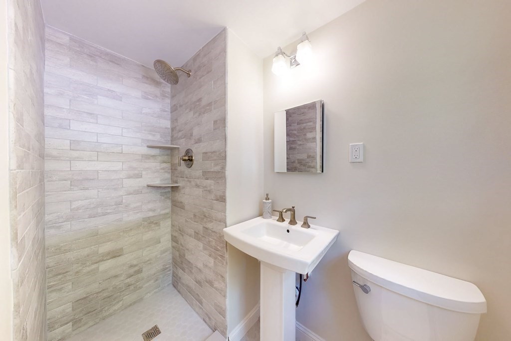 11 Stagecoach Road Medfield, MA 02052 - Photo 18 of 38 a bathroom with a sink toilet and shower