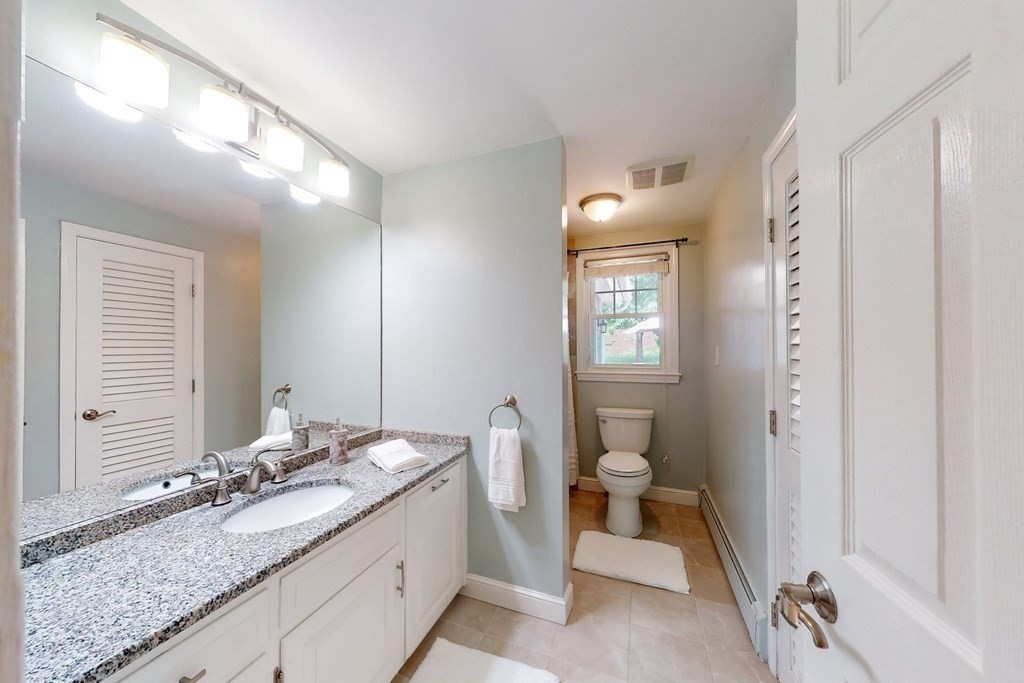 11 Stagecoach Road Medfield, MA 02052 - Photo 23 of 38 a bathroom with a granite countertop sink and a mirror