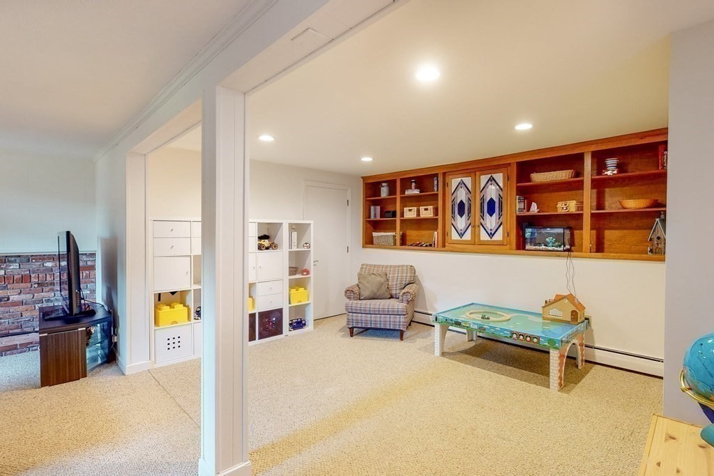 11 Stagecoach Road Medfield, MA 02052 - Photo 28 of 38 a living room with furniture gym equipment and a chandelier