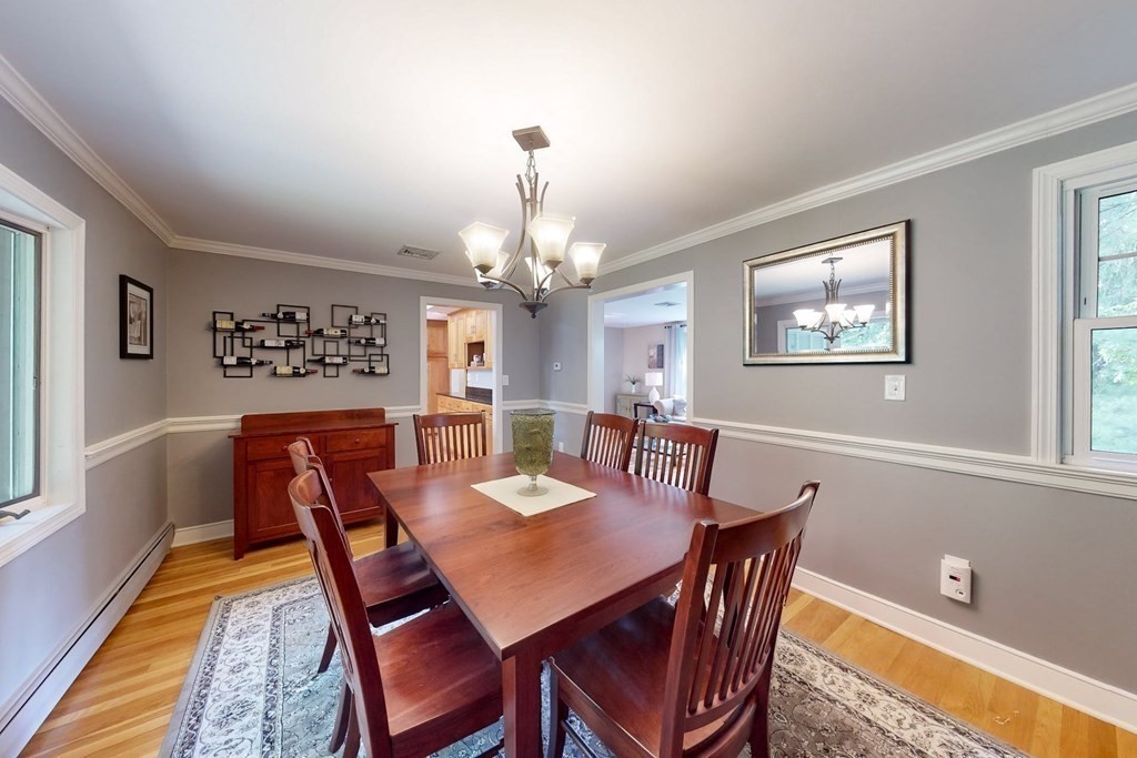 11 Stagecoach Road Medfield, MA 02052 - Photo 9 of 38 a view of a dining room with furniture a chandelier and wooden floor