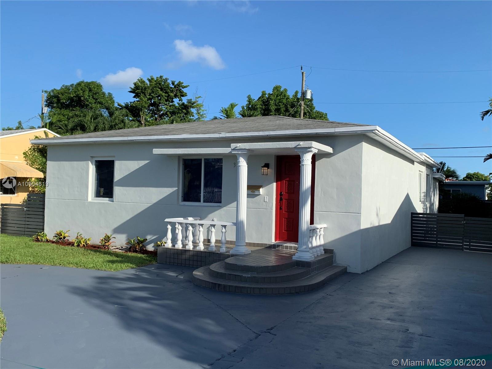 3670 Northwest 16th Street Miami, FL 33125 - Photo 1 of 17 a front view of a house with a yard