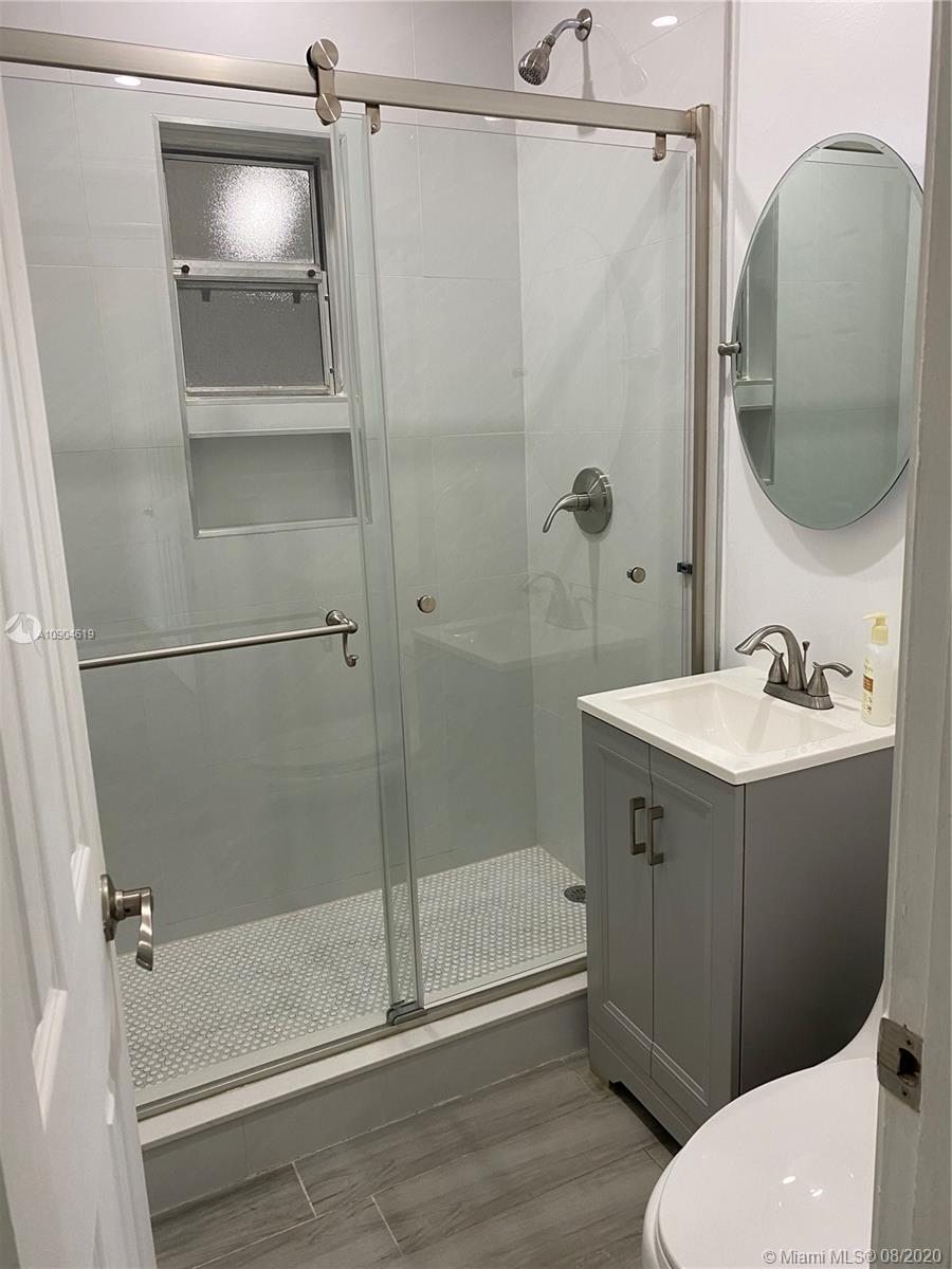 3670 Northwest 16th Street Miami, FL 33125 - Photo 12 of 17 a bathroom with a sink a toilet and shower