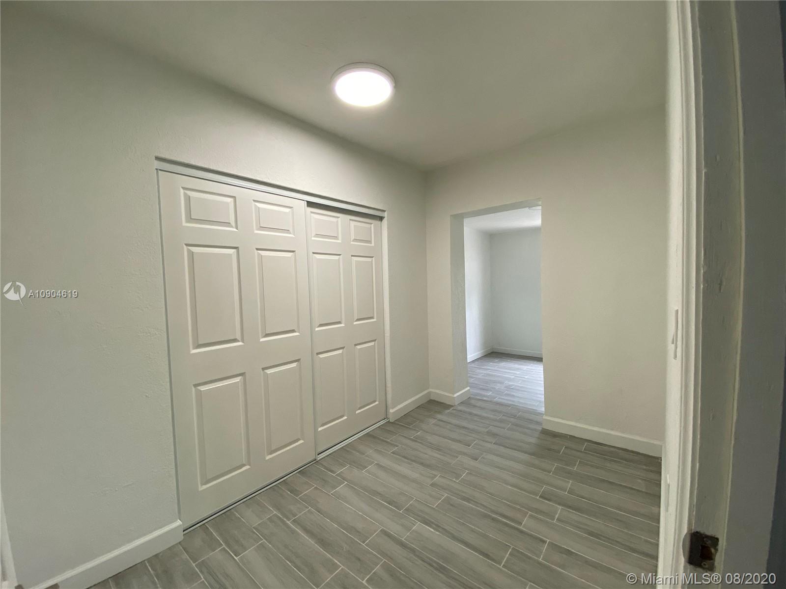3670 Northwest 16th Street Miami, FL 33125 - Photo 13 of 17 a view of empty room with wooden floor