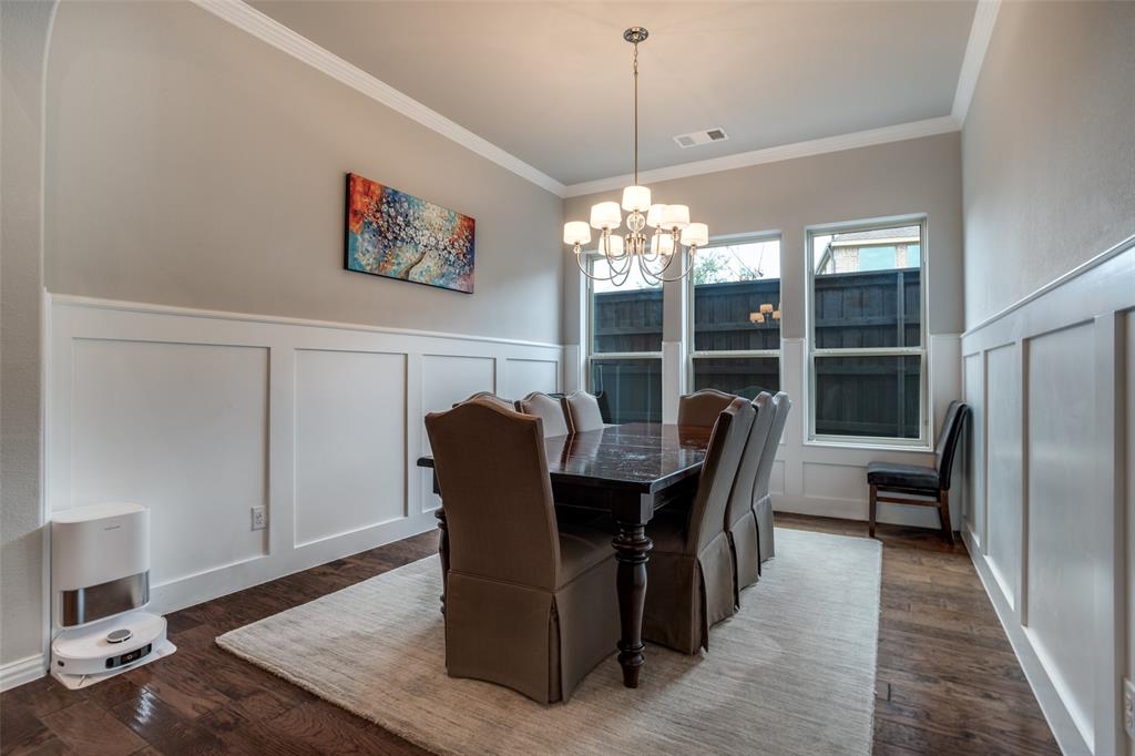 3410 Challis Trail McKinney, TX 75070 - Photo 12 of 31 a dining room with furniture a chandelier and wooden floor