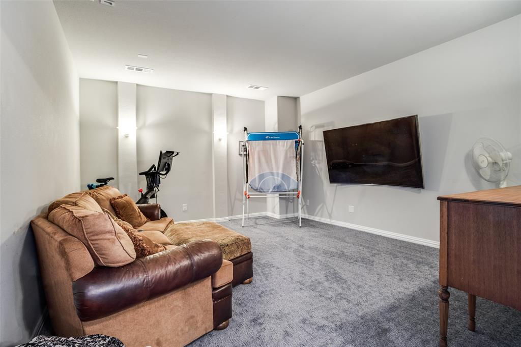 3410 Challis Trail McKinney, TX 75070 - Photo 20 of 31 a living room with furniture and a flat screen tv