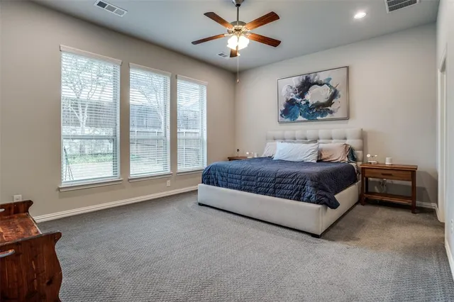 a bedroom with a bed and a painting on the wall